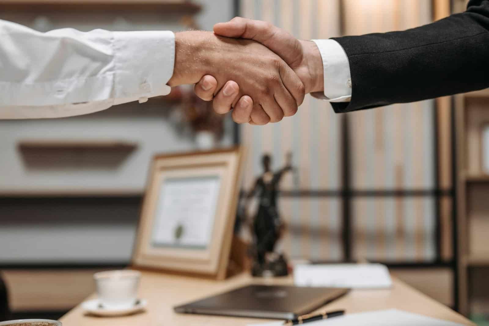 real estate investor purchasing a rental property shaking hands