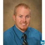 Founder'S Story: Professional Headshot Of David J Moore, Mba Smiling Businessman In Blue Shirt And Tie. Leadership Portrait.